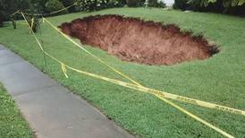Neighbors in Cobb County worried that large sinkholes will swallow up their homes