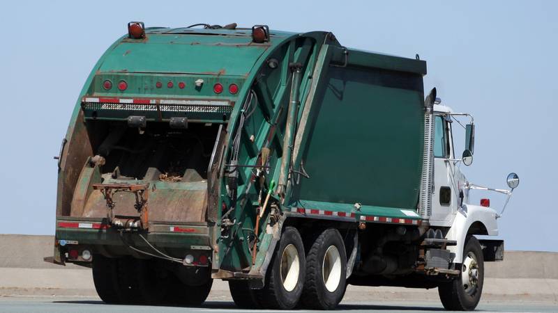 Woman rescued after falling into dumpster when throwing out trash, gets stuck in trash truck