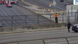 Police activity involving man sitting on overpass sign is impacting traffic on I-75