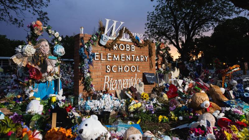 A memorial at the sign for Robb Elementary School in Uvalde, Texas.