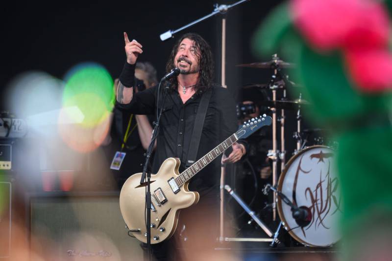 GLASTONBURY, ENGLAND - JUNE 23: Dave Grohl of the Foo Fighters gestures to the sky after referring to the late drummer Taylor Hawkins as the band perform on the Pyramid Stage on Day 3 of Glastonbury Festival 2023 on June 23, 2023 in Glastonbury, England. The Glastonbury Festival of Performing Arts sees musicians, performers and artists come together for three days of live entertainment. (Photo by Leon Neal/Getty Images)