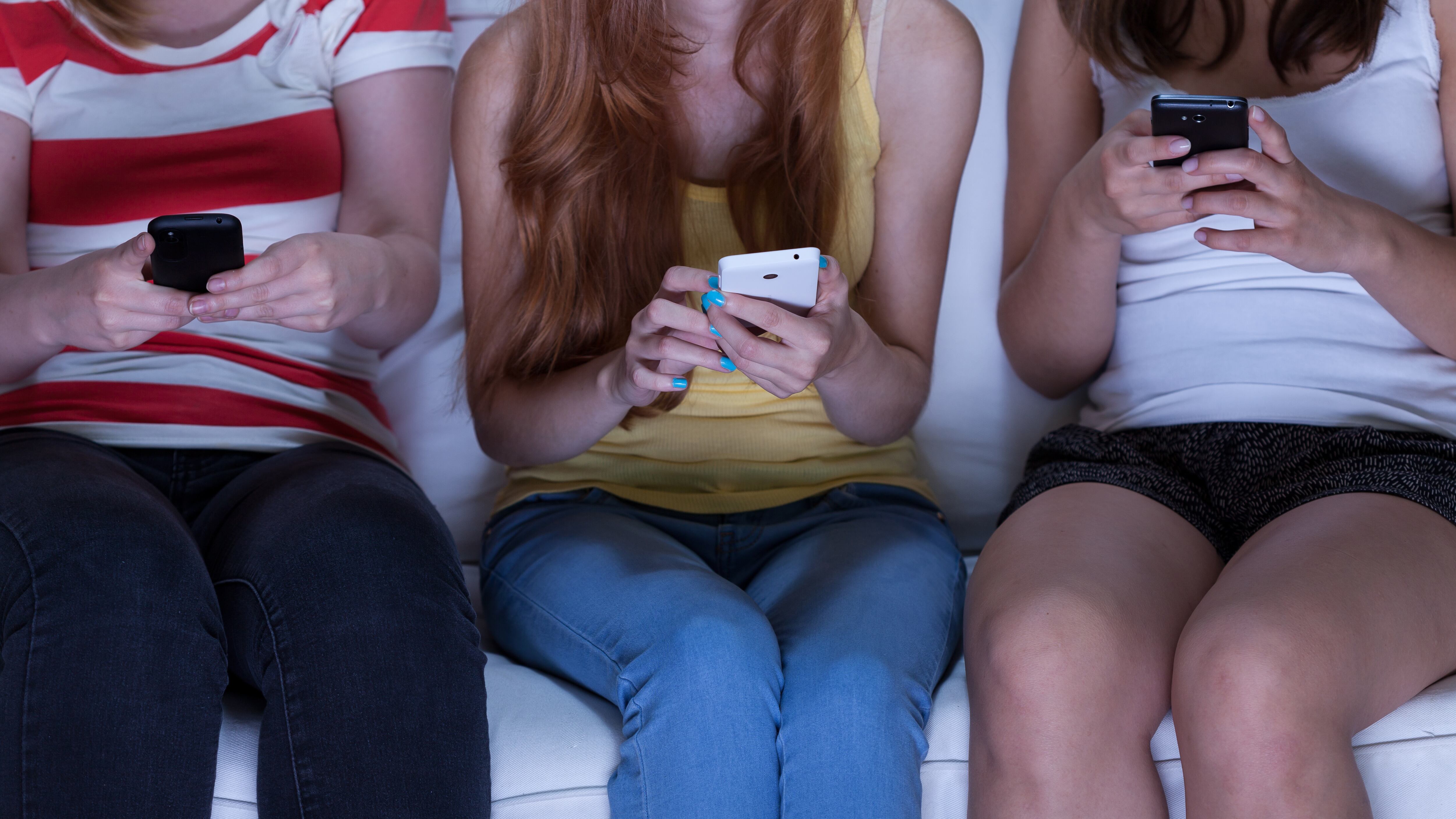 Friend sitting on couch and sending text messages