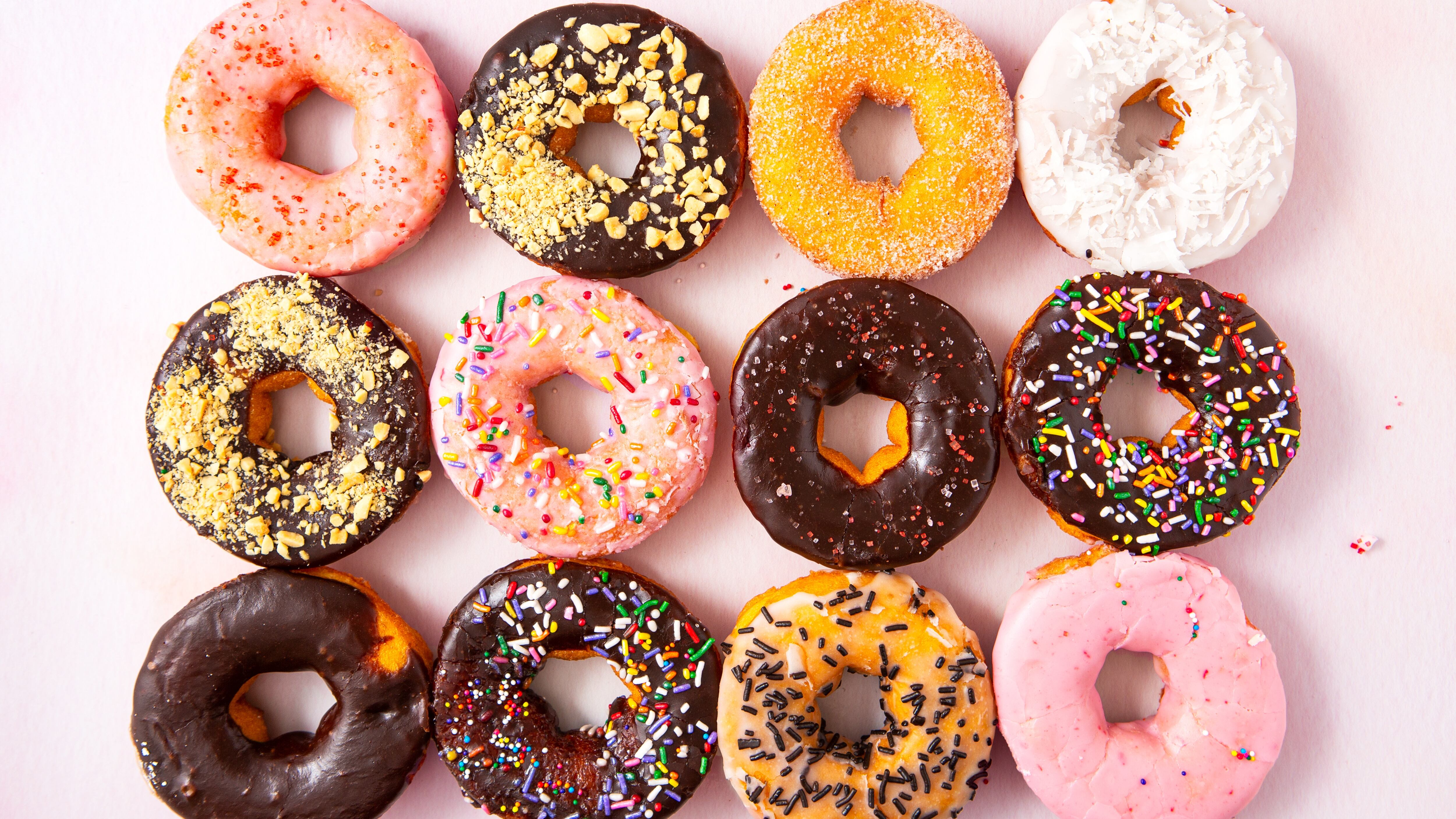 Overhead view of a dozen freshly baked doughnuts