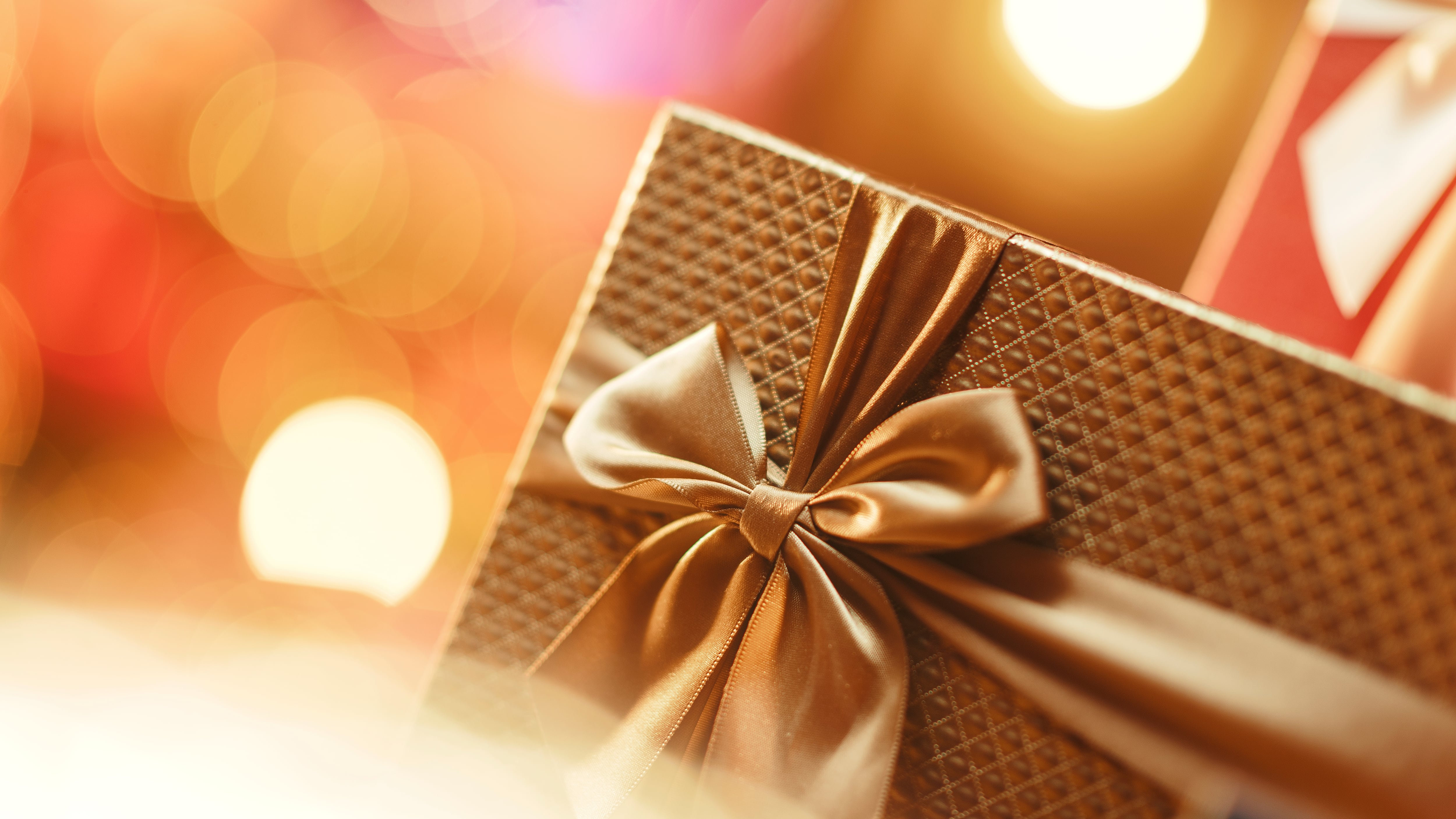 Luxury golden Christmas gift with ribbon and lights