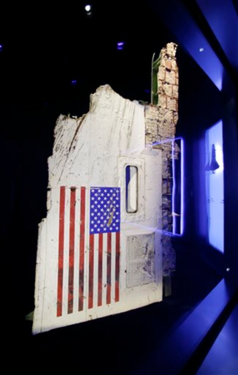 In this Tuesday, July 21, 2015, photo, the left side body panel of space shuttle Challenger is displayed in a glass case at the "Forever Remembered" exhibit at the Kennedy Space Center Visitor Complex in Cape Canaveral, Fla. Challenger's wreckage _ all 118 tons of it, salvaged from the Atlantic _ was buried in a pair of former missile silos, 90 feet deep. The chamber containing this particular fuselage section had never been opened _ until the exhibit began to take shape. (AP Photo/John Raoux)