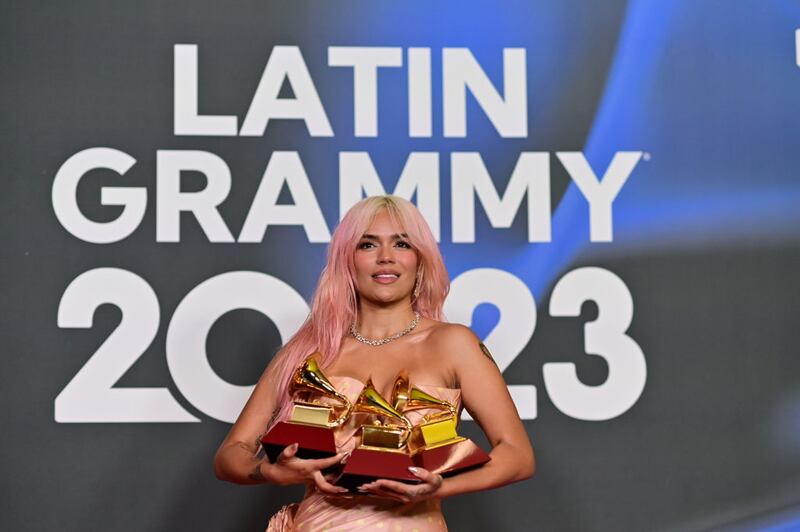 SEVILLE, SPAIN - NOVEMBER 16: Karol G poses with the awards for Best Recording of the Year, Best Urban Album of the Year, and Best Album of the Year in the media center for The 24th Annual Latin Grammy Awards at FIBES Conference and Exhibition Centre on November 16, 2023 in Seville, Spain. (Photo by Niccolo Guasti/Getty Images)