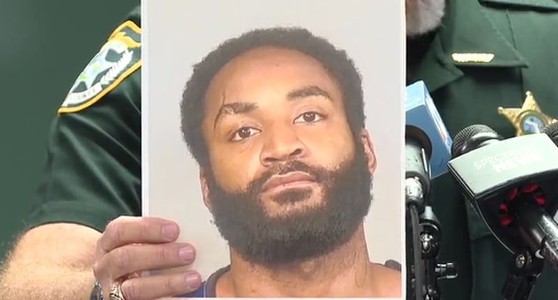 Manatee County Sheriff Rick Wells holds up a photo of 28-year-old Javontee Brice, who killed his mother, a cousin and another woman before being killed in a shootout with Hamilton County deputies, authorities say.
